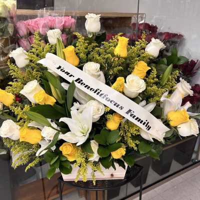 Yellow and white roses with lilies in a wooden box