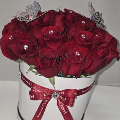 Red rose bouquet in a white hat box with a ribbon bow