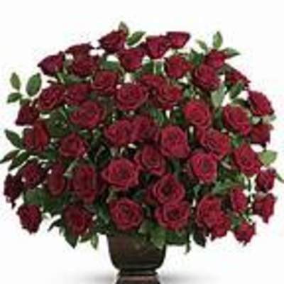 Large bouquet of red roses in a dark vase
