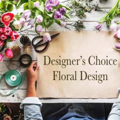Designer’s Choice Floral Design sign surrounded by tulips and floral tools