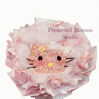 Round pink bouquet styled like a cat face, wrapped in layered pink paper.