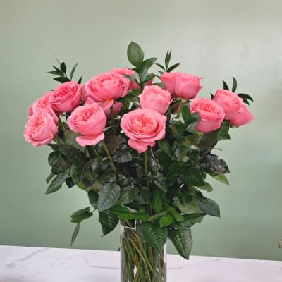 Pink roses arranged in a clear glass vase