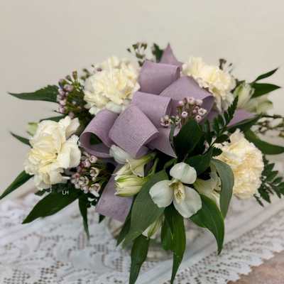 White floral bouquet with lavender ribbon and greenery