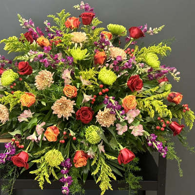 Large mixed bouquet of red, orange, and pink flowers
