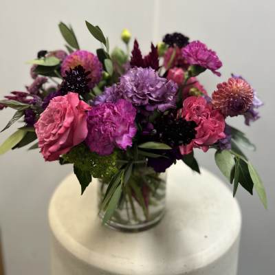 Mixed pink and purple bouquet in a glass vase