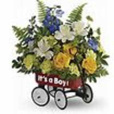 Mixed flower arrangement in a red wagon with white wheels