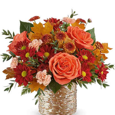 Orange roses and red chrysanthemums in a woven basket vase