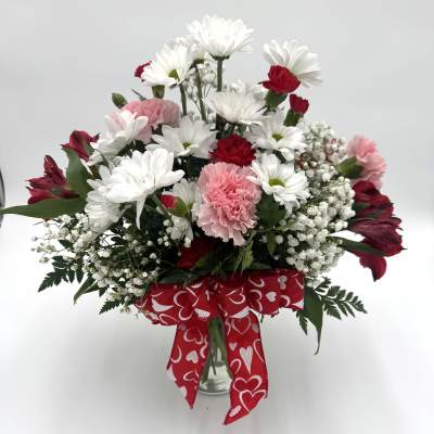 Bouquet of white daisies and pink carnations with a red heart ribbon