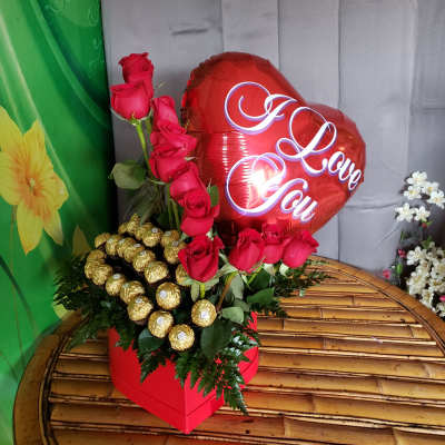 heart-shaped box with roses and chocolate