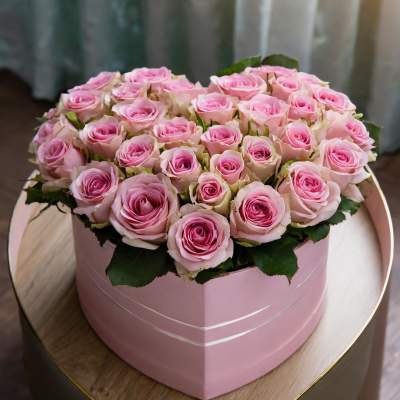 Pink roses arranged in a round pink box