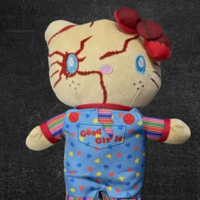 Plush doll with a cracked face and red flower accents