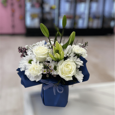 White rose and lily bouquet in a blue box