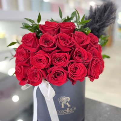 Bouquet of red roses in a gray hat box with a white ribbon