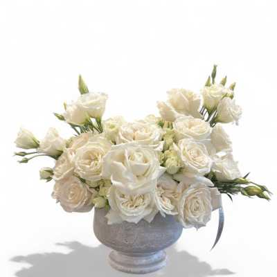 White rose bouquet in a gray pedestal vase