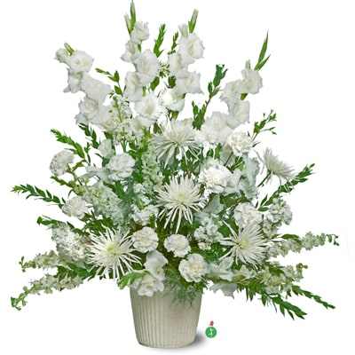 Tall all-white arrangement with carnations, spider mums, and other blooms in a white ribbed pot.