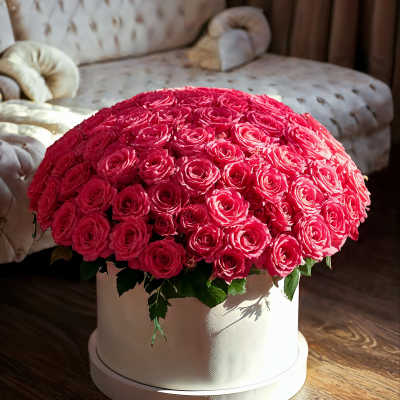 Large dome arrangement of bright pink roses in a white round box
