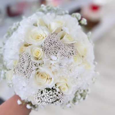 White rose bouquet with pearl-like accents and lace details