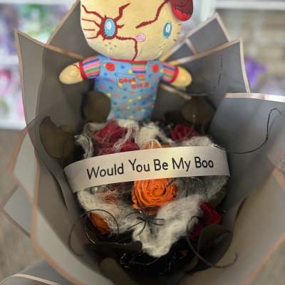 Bouquet with a plush doll and orange roses wrapped in gray paper