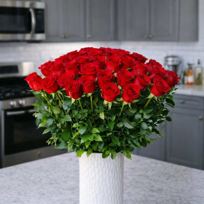 Large bouquet of red roses in a white vase