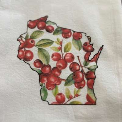 Wisconsin-shaped design filled with red berries and green leaves