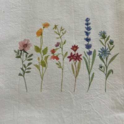 Small embroidered wildflower stems in pink, orange, red, blue, and purple