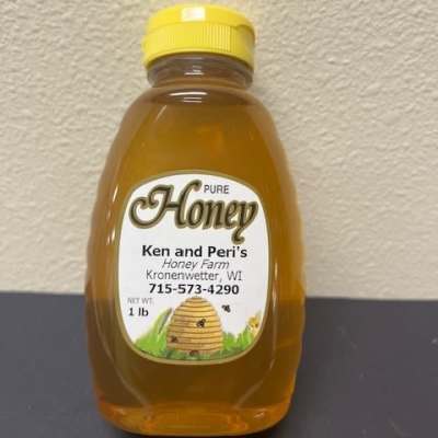 Bottle of pure honey with a yellow cap and labeled front