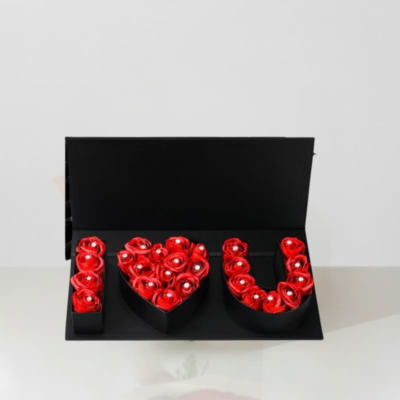 Red roses arranged in a black box to spell "I LOVE U"