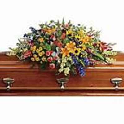Colorful floral spray on a wooden casket