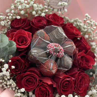 Bouquet of red roses with white baby's breath and chocolate-covered strawberries