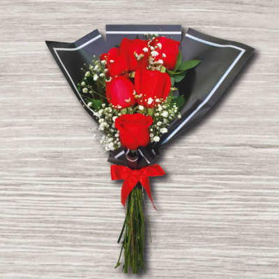 Bouquet of red roses wrapped in black paper with a red ribbon
