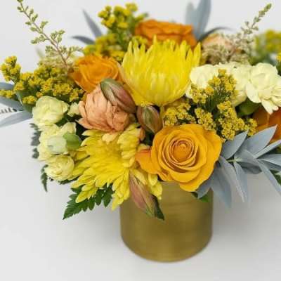 Yellow and orange bouquet in a gold vase