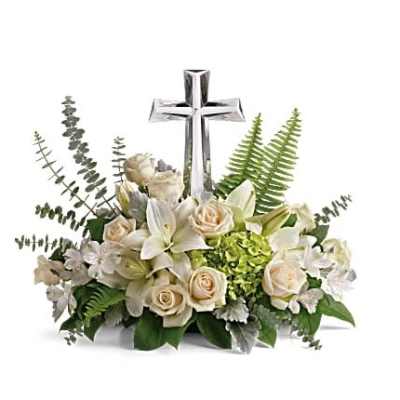 White floral arrangement with a silver cross centerpiece