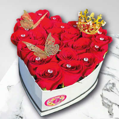 Heart-shaped box of red roses with butterfly and crown decorations