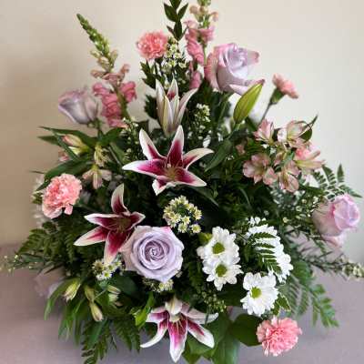 Bouquet of pink and lavender flowers with lilies and roses