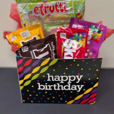 Birthday gift bag filled with assorted candy packages