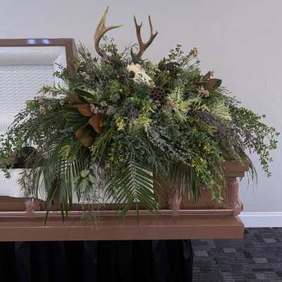 Large casket spray with antlers and mixed greenery