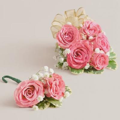 Pink rose bouquet and matching boutonniere with white filler flowers