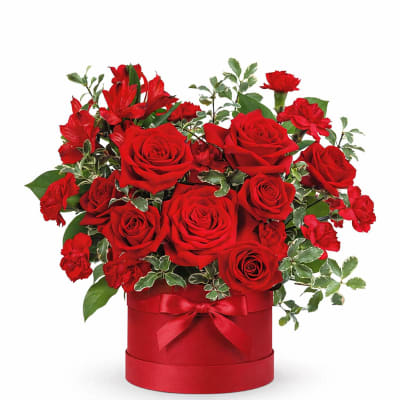 Red roses and carnations in a red hat box with a ribbon