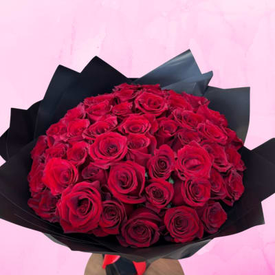 Bouquet of red roses wrapped in black paper