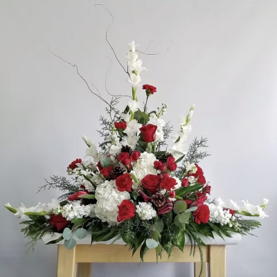 Large red and white floral arrangement with tall white blooms and branches