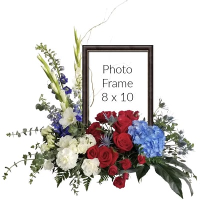 Floral photo frame arrangement with red roses, blue hydrangea, and white flowers