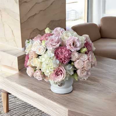 Pink and white rose bouquet in a white vase