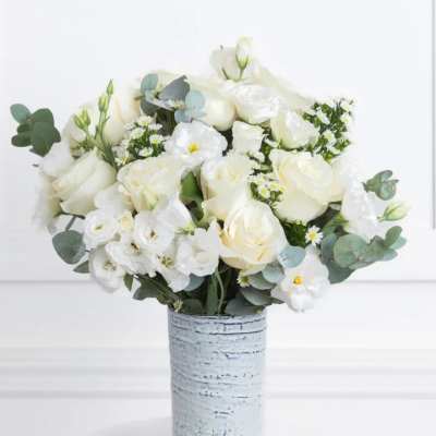 White rose bouquet in a textured silver vase