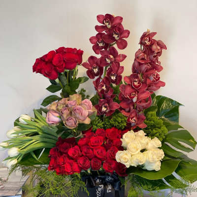 Red & White Roses, Tulips, Cymbidium & Leaves Floral Garden Arrangement