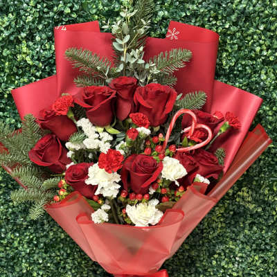 Bouquet of red roses with white carnations and a candy cane accent
