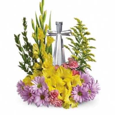 Yellow and purple floral arrangement with a silver cross centerpiece