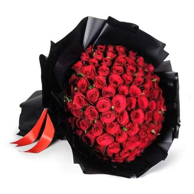 Bouquet of red roses wrapped in black paper with a red ribbon