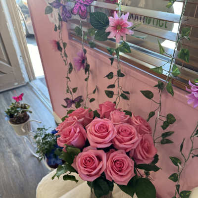 Pink roses arranged in a clear glass vase
