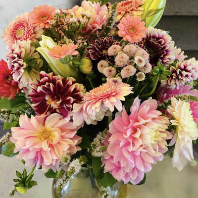 Bouquet of pink and peach flowers in a glass vase