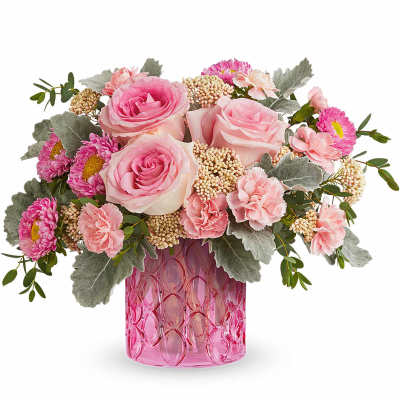 Pink roses and carnations in a pink glass vase